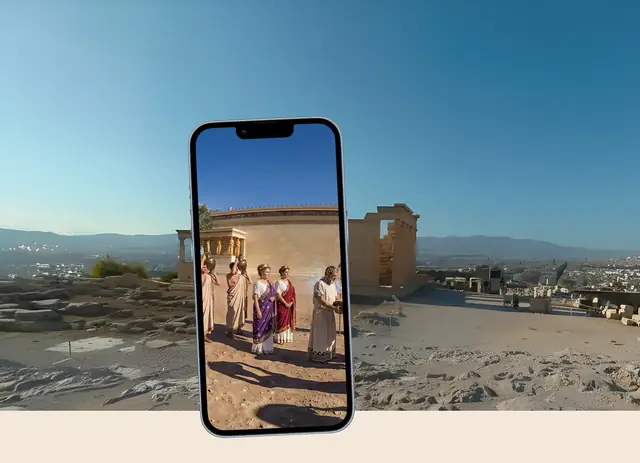 Phone showing a TimeLens reconstruction of the Erechtheion on the Acropolis in Athens, held up in front of the ruins today